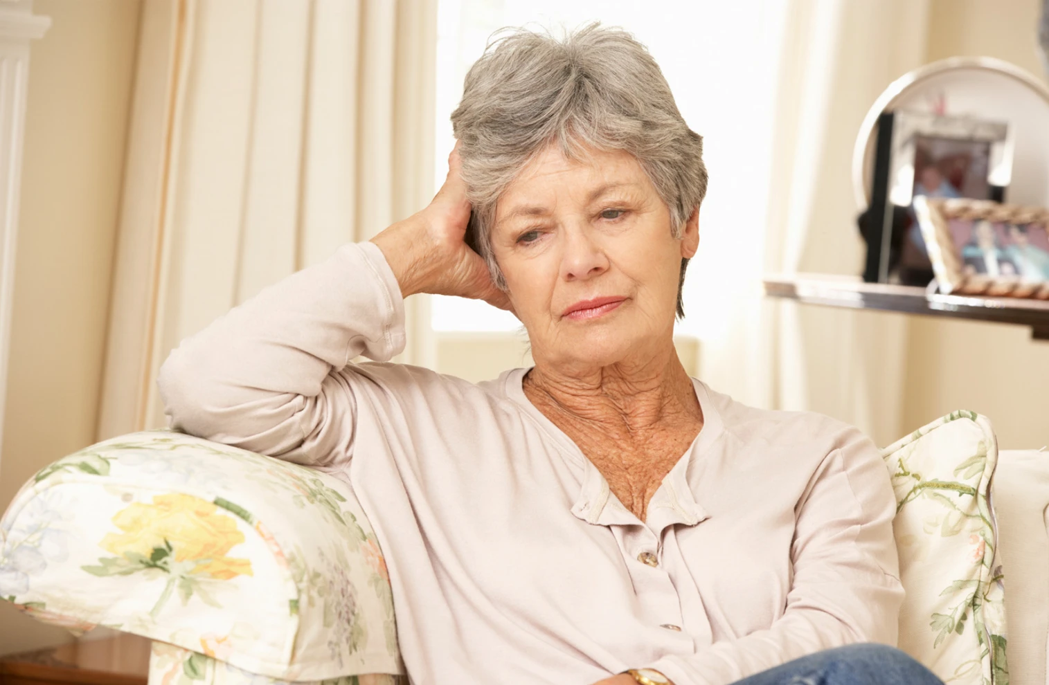 woman sitting on couch alone and lonely