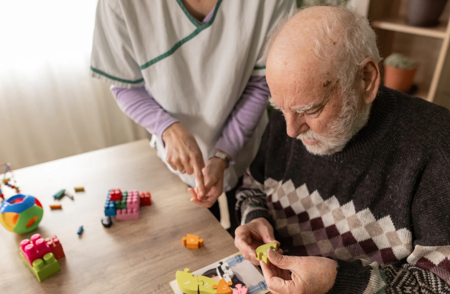 elderly man with caregiver and memory puzzles