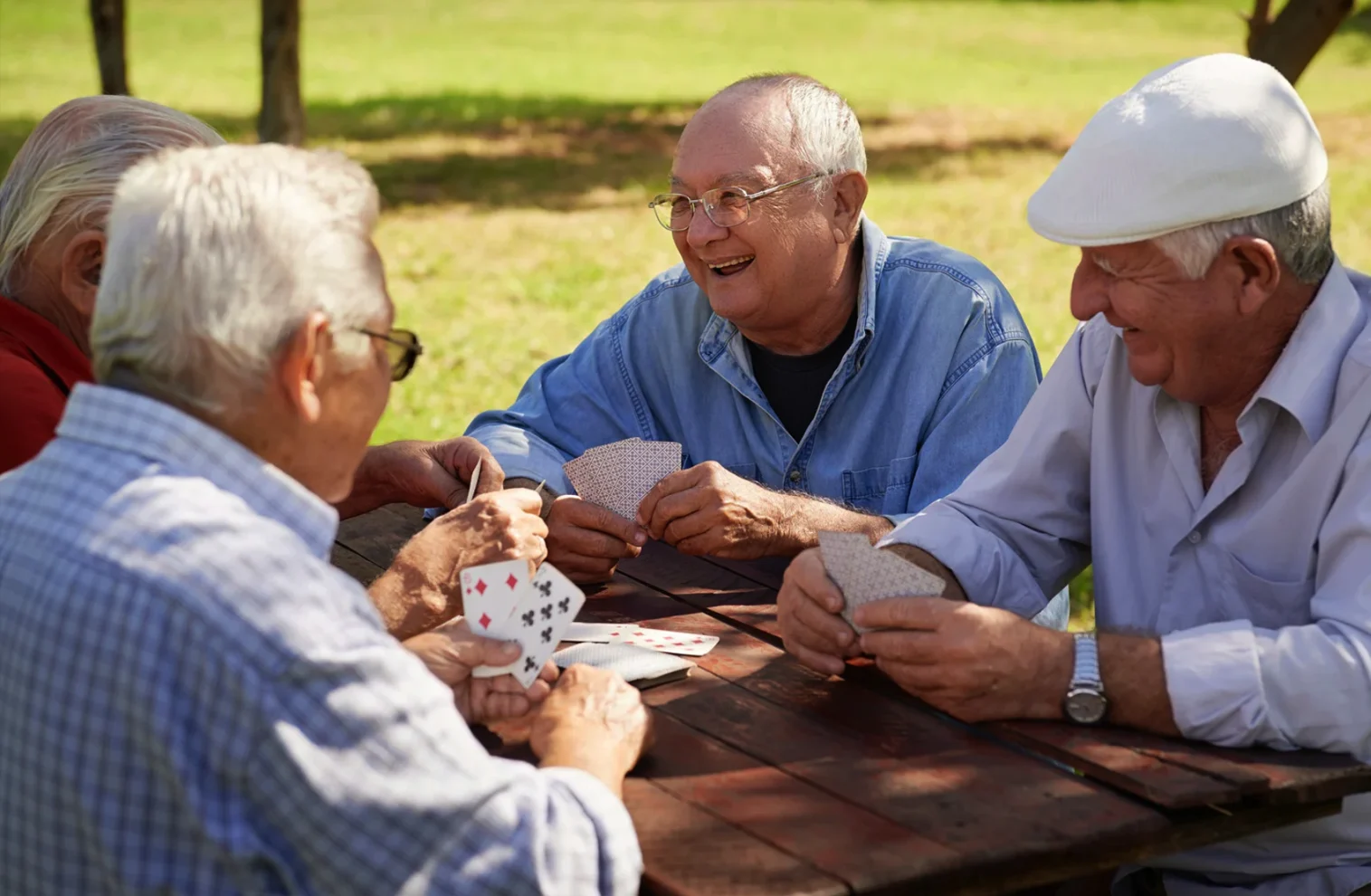 group of elderly men playing cards