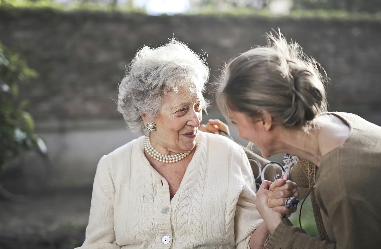 elderly mother with daughter visiting