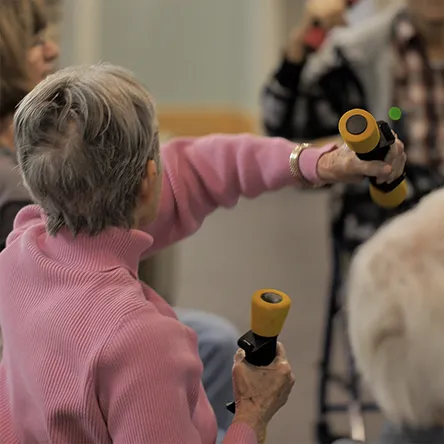 resident in exercise class with light weights