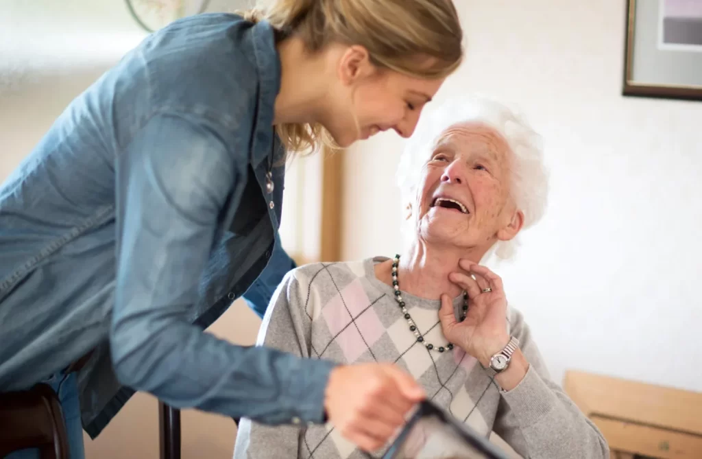 Caregiver assisting senior woman